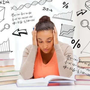A girl is sitting at her desk with books